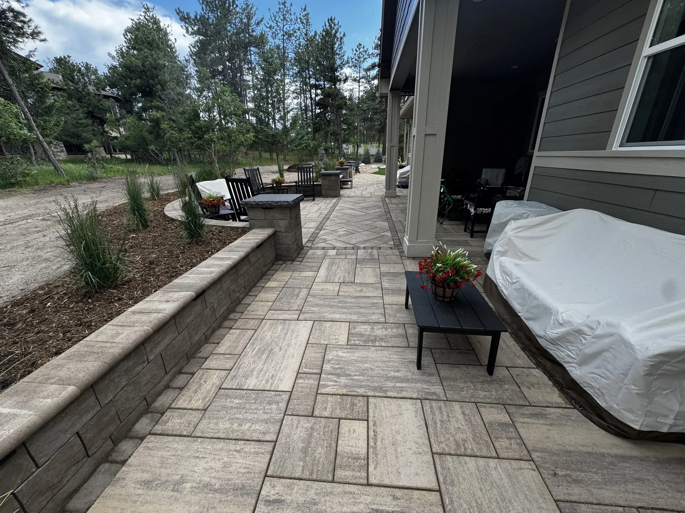 Paver walkway and seat wall along the home's covered patio in Larkspur